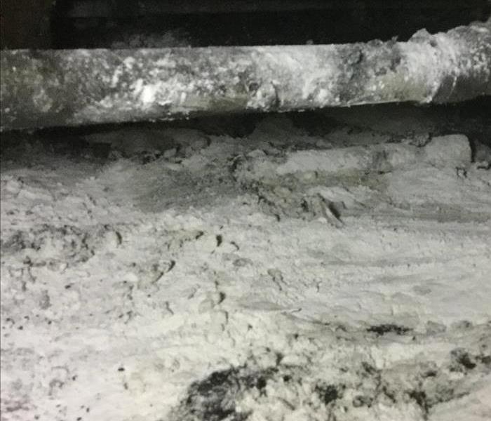 Dry sand in a crawl space