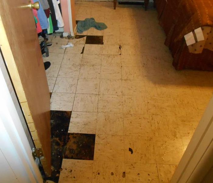 Tile floor separating from the concrete underneath due to water