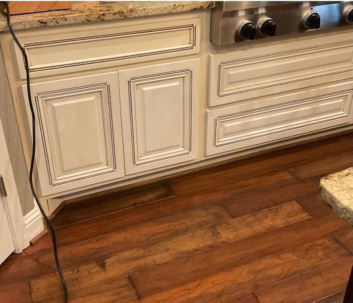 warped hardwood flooring in a kitchen