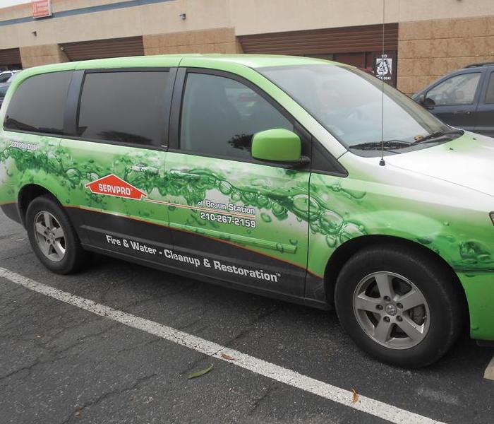 Vehicle in a SERVPRO green bubble wrap in a parking lot