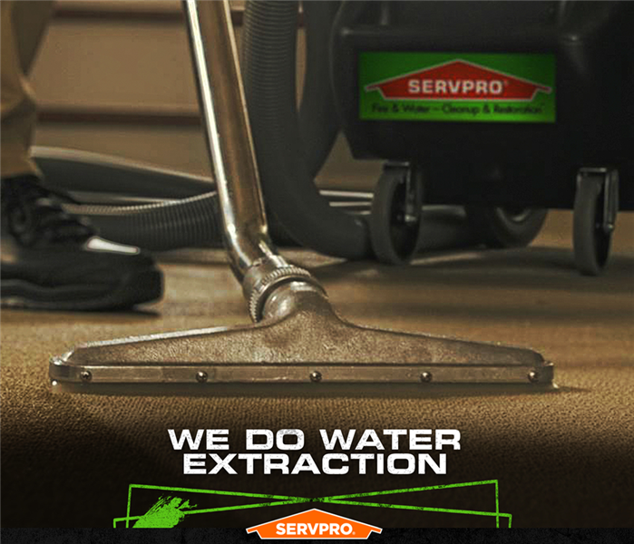 SERVPRO tech extracting contaminated water from carpet with caption: WE DO WATER EXTRACTION