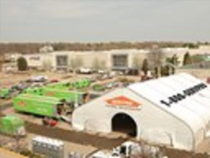 SERVPRO tent and several green vehicles outside of the large tent